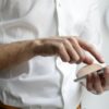 person holding white Android smartphone in white shirt