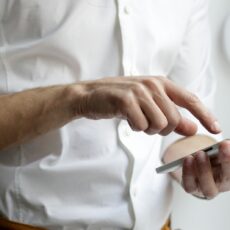 person holding white Android smartphone in white shirt