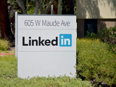 brown wooden signage on green grass field