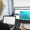 woman sitting in front of turned-on computer monitor