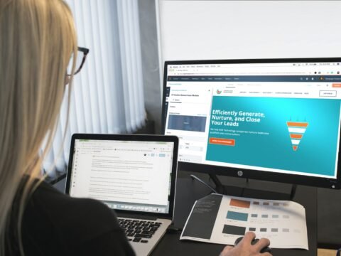 woman sitting in front of turned-on computer monitor